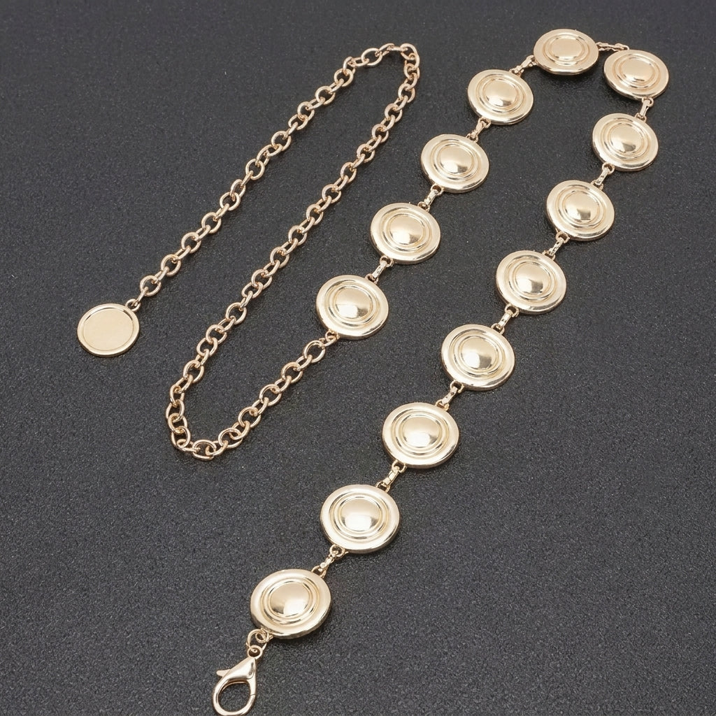 Gold necklace and bracelet with circular links on dark surface.