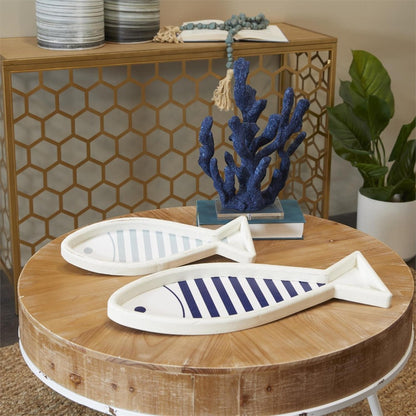 Coastal decor with wooden fish, blue coral, and geometric accents.