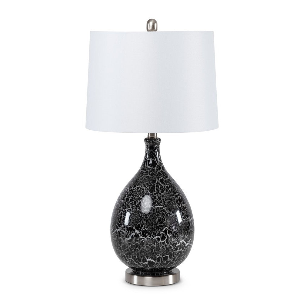 Black and white ceramic table lamp with a white shade.