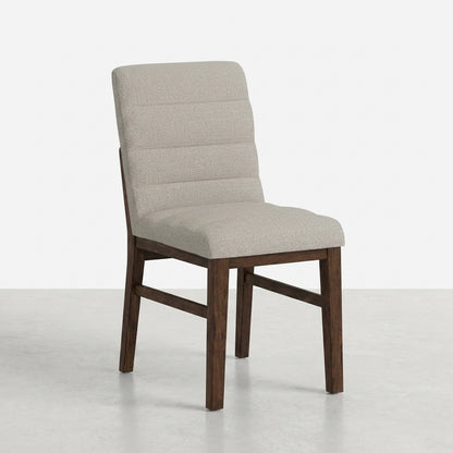 Side view of a cushioned chair with a dark wooden frame.