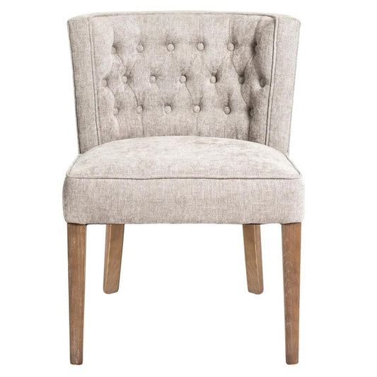 Beige upholstered chair with tufted back and wooden legs.
