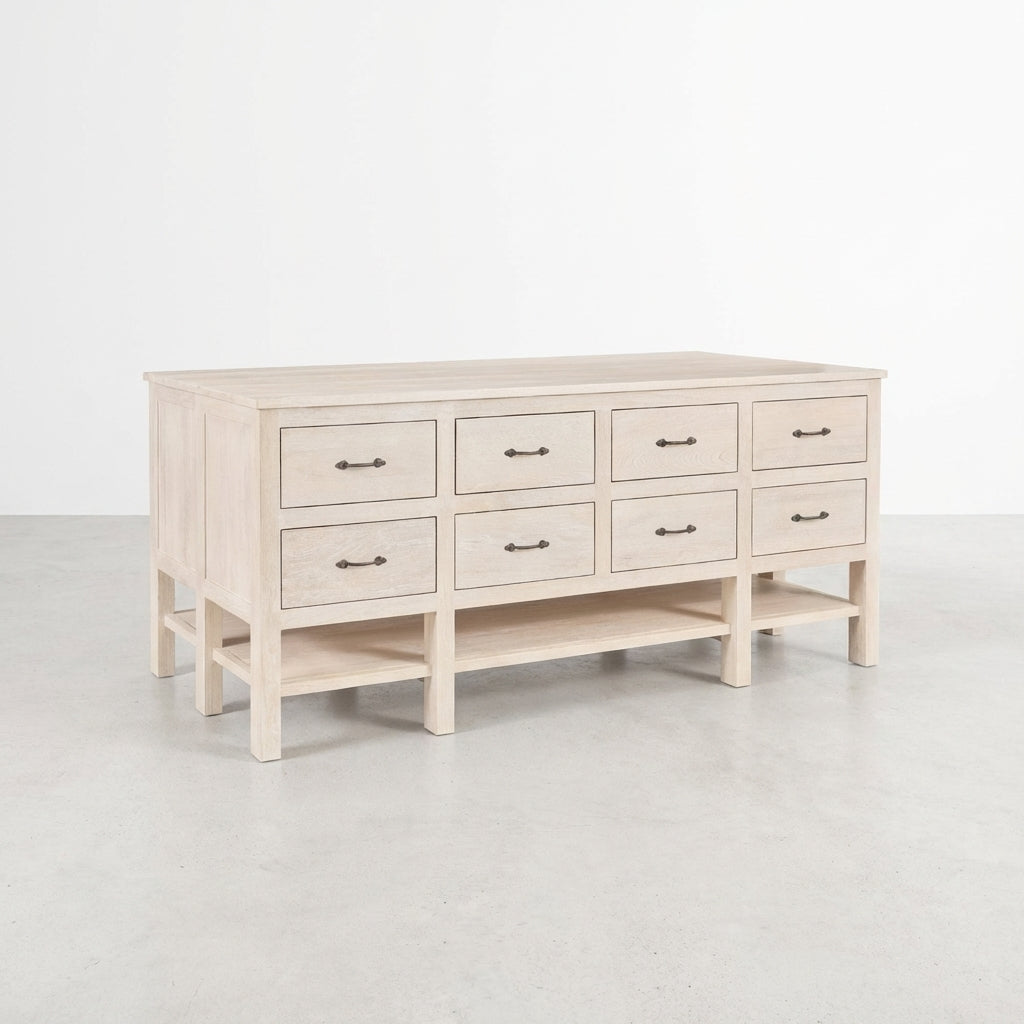 Light wood dresser with eight drawers and a lower shelf.
