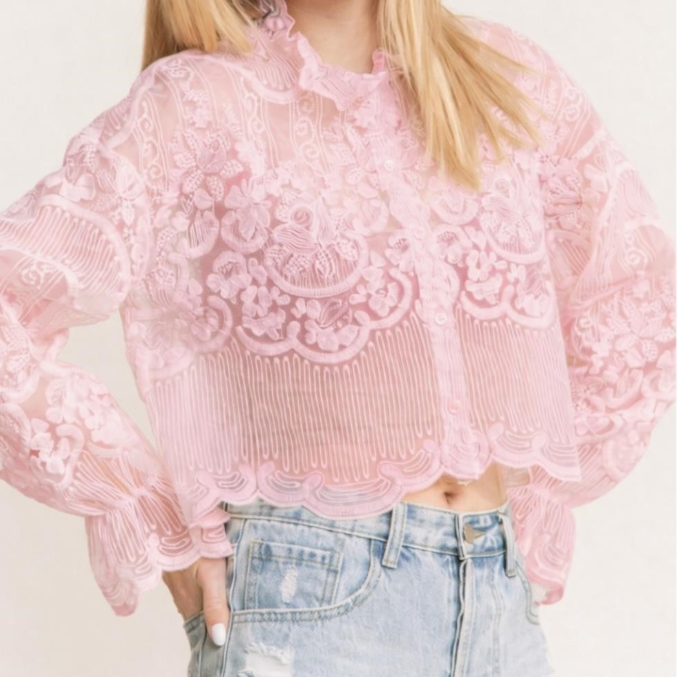 Pink lace blouse and denim shorts.