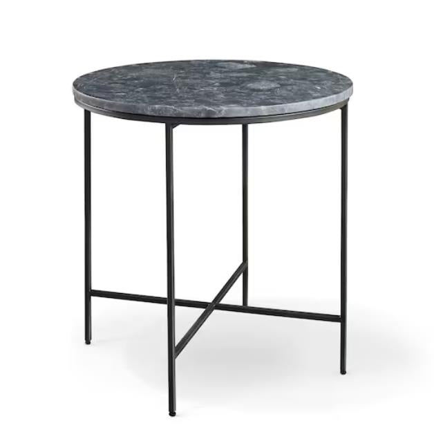 Round marble table with thin black metal legs.