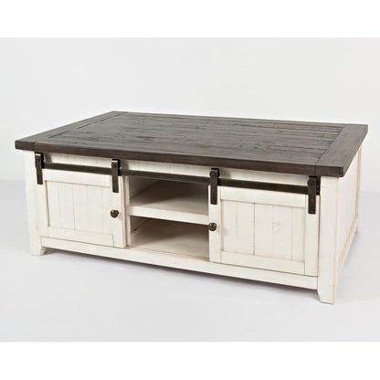 Rustic white coffee table with dark wooden top and sliding barn doors.