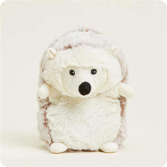 Fluffy hedgehog plush toy on a plain background.