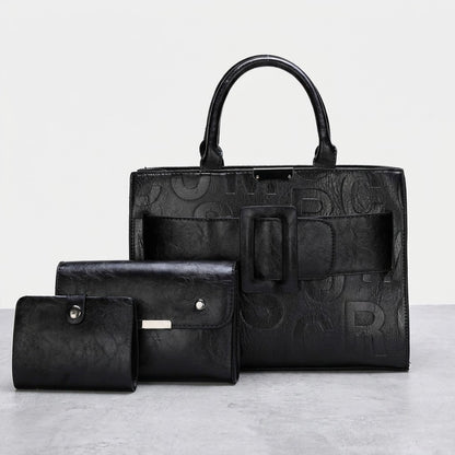 Black leather bag and two matching wallets on display.