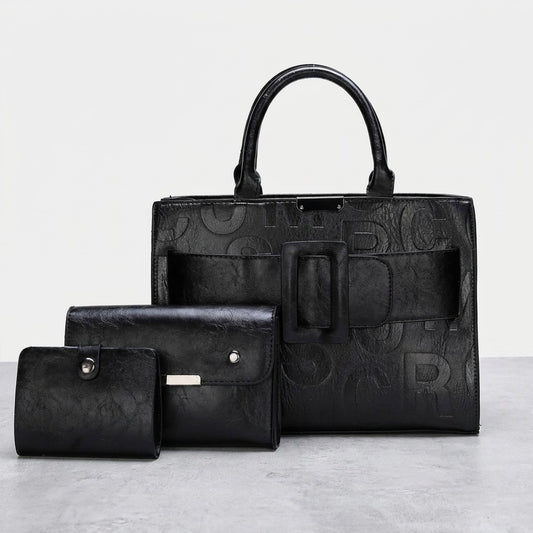 Black leather bag and two matching wallets on display.