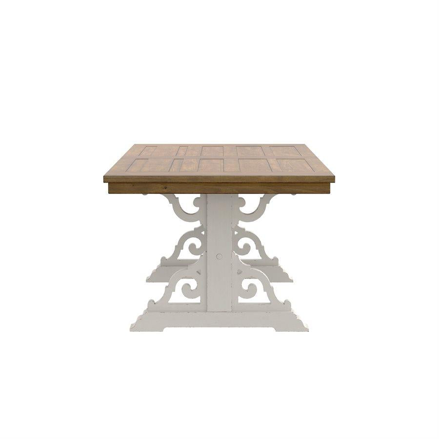 Wooden table with ornate white metal base, front view.
