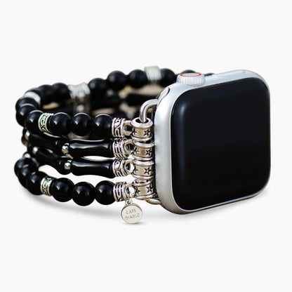 Smartwatch with black beaded band and decorative silver elements.