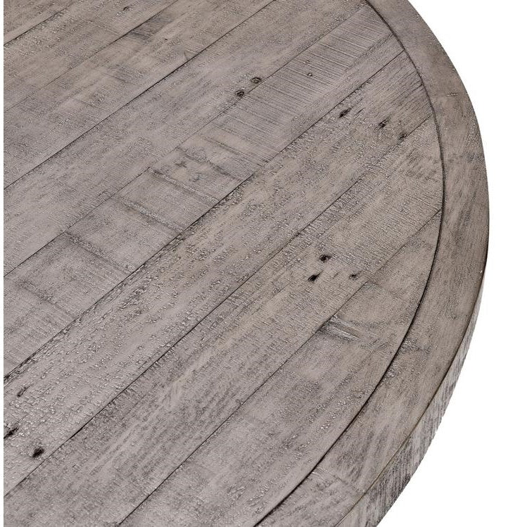 Close-up of a round wooden table with a gray, rustic finish.