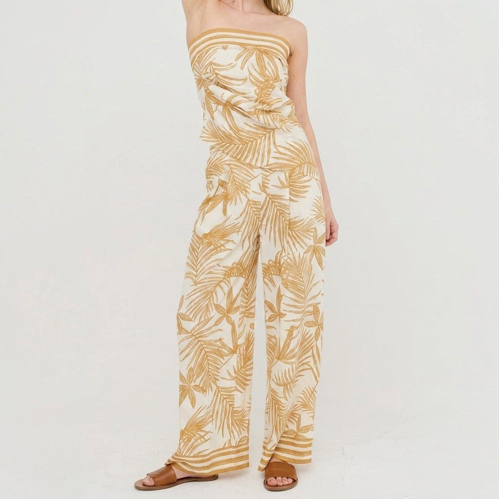 Model in leaf-patterned, strapless jumpsuit with sandals.