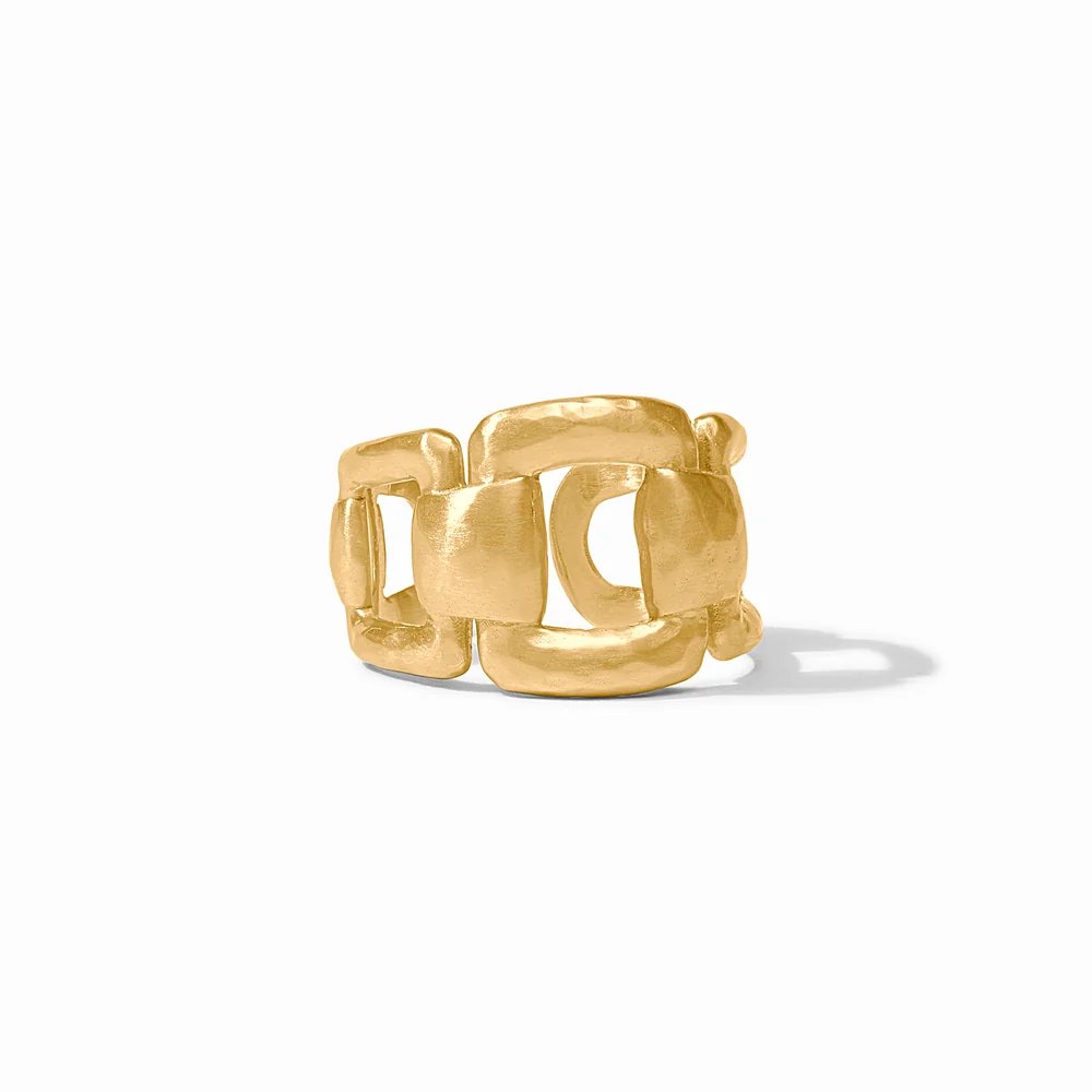 A sculptural gold ring with interlocking geometric links on a white background.