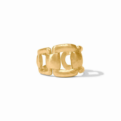 A sculptural gold ring with interlocking geometric links on a white background.