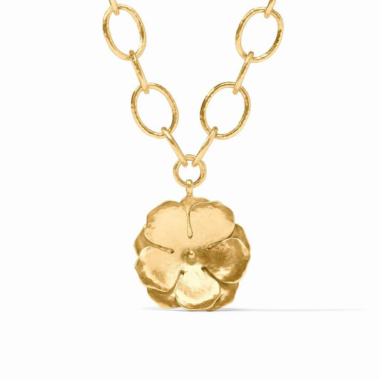 A gold chain necklace with oval links and a textured flower pendant.