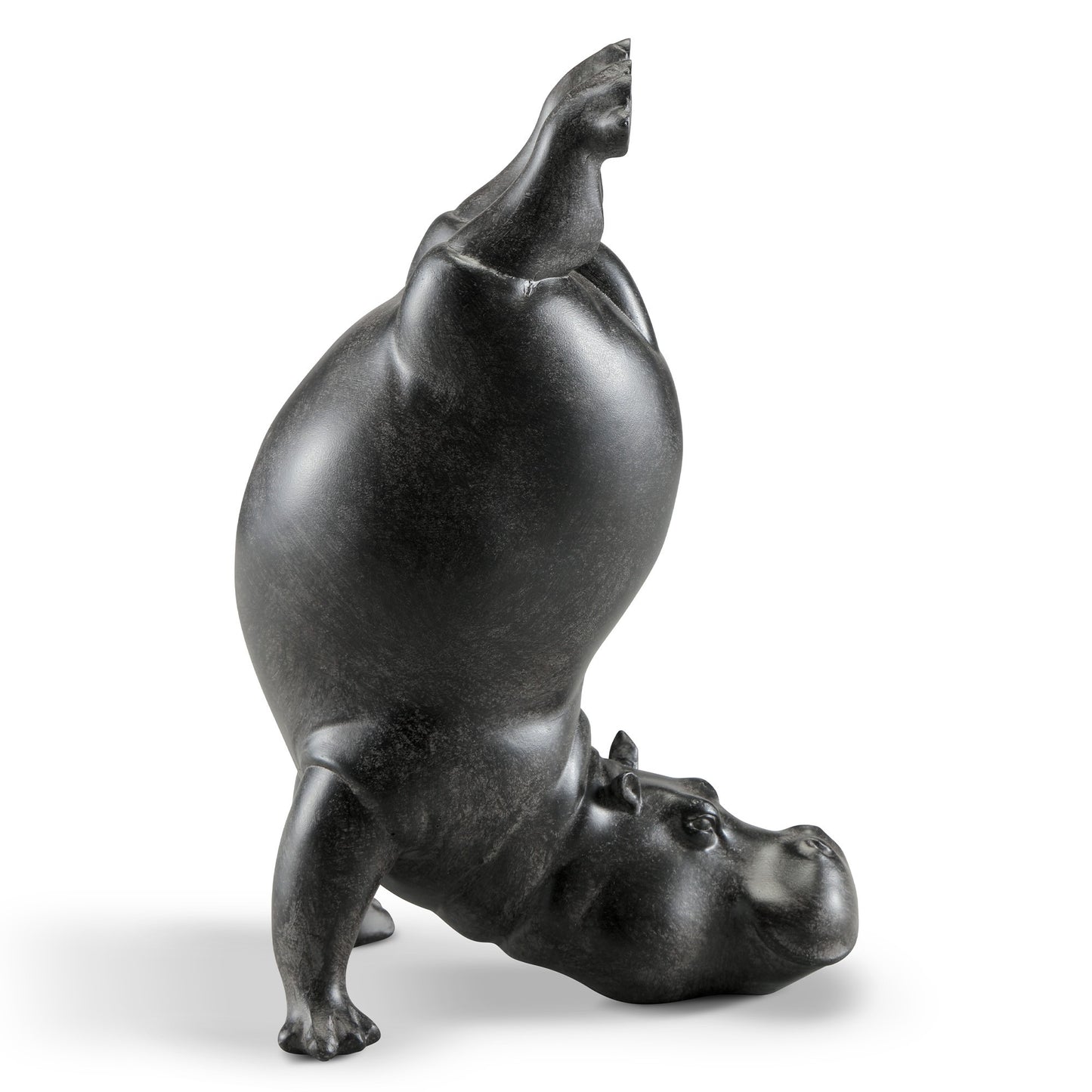 Black hippo sculpture doing a headstand.