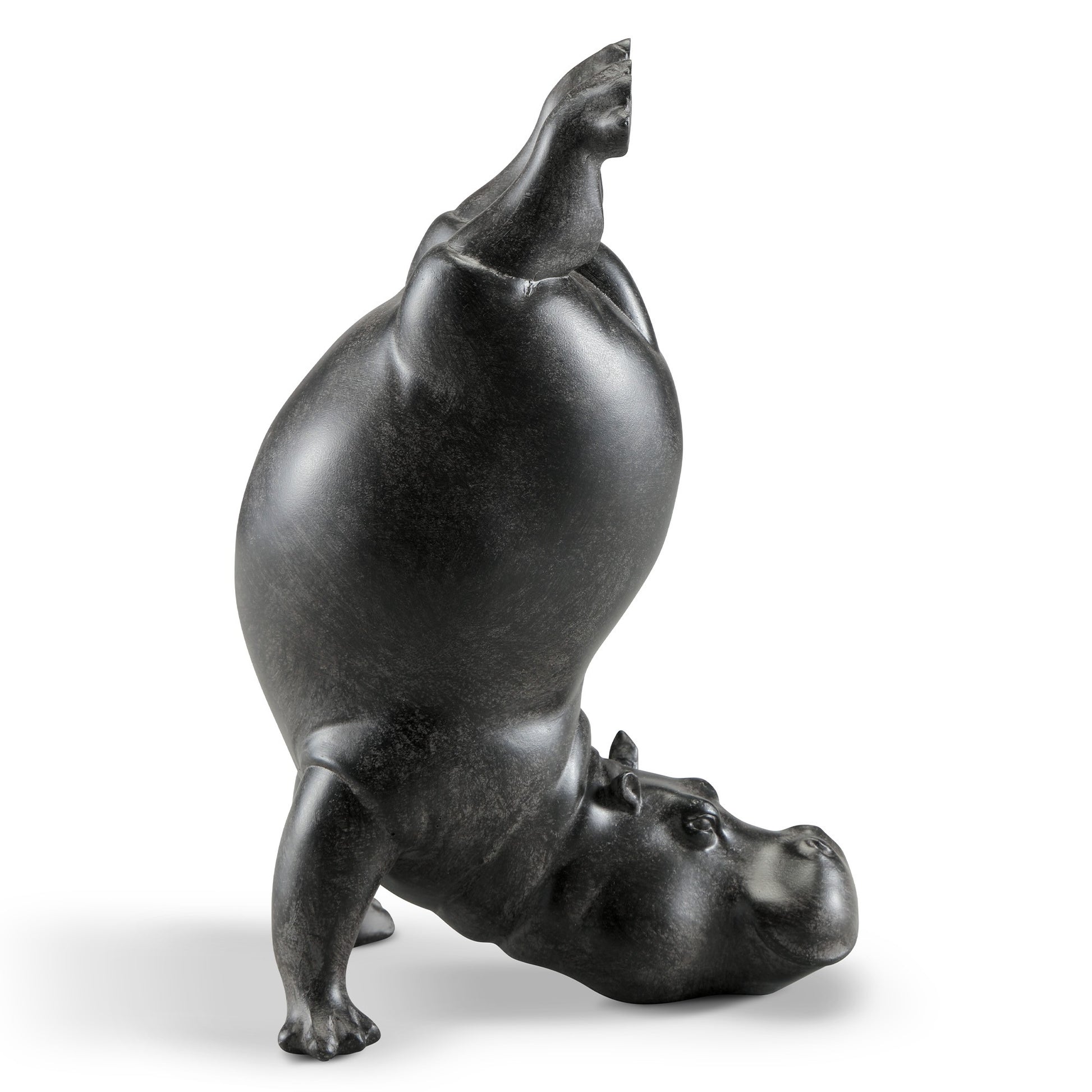 Black hippo sculpture doing a headstand.
