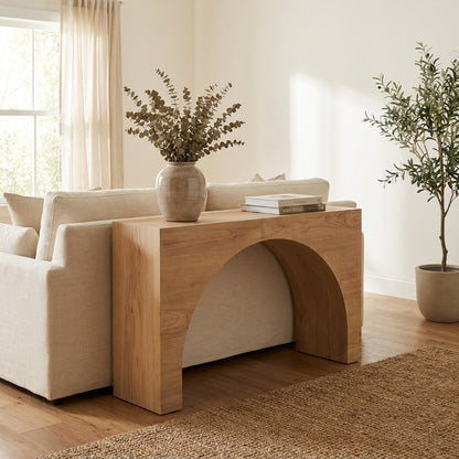 Wooden console table with an arch cutout design.