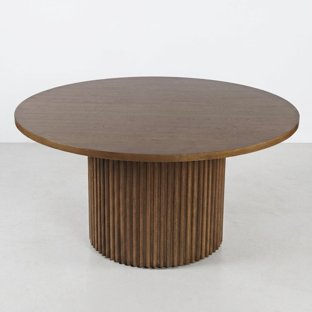 Round wooden table with a fluted cylindrical base.