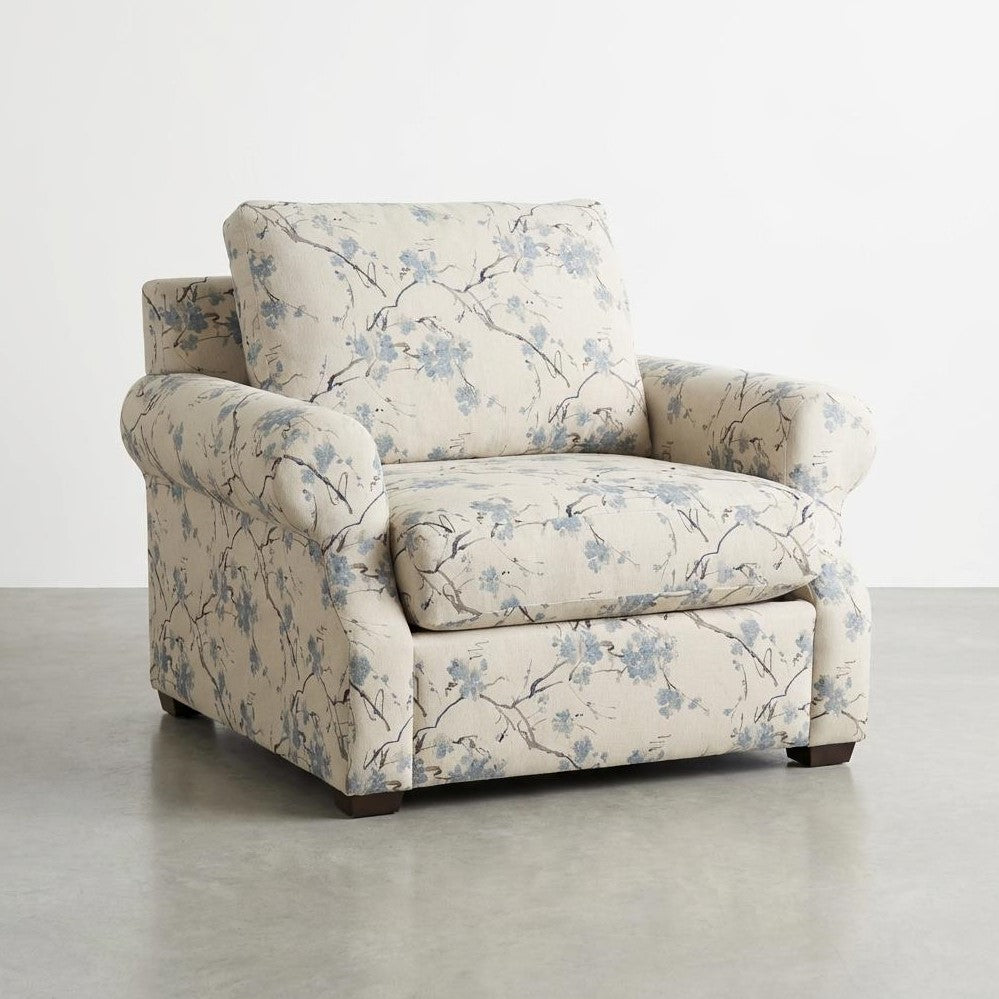 Floral-patterned armchair on a gray floor.