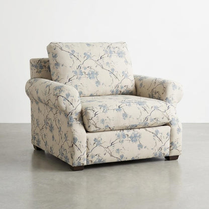 Floral-patterned armchair on a gray floor.