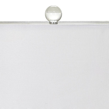 Crystal ball atop a white textured canvas.