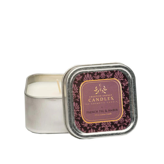 Square tin candle labeled "French Fig & Amber" with a decorative purple design.
