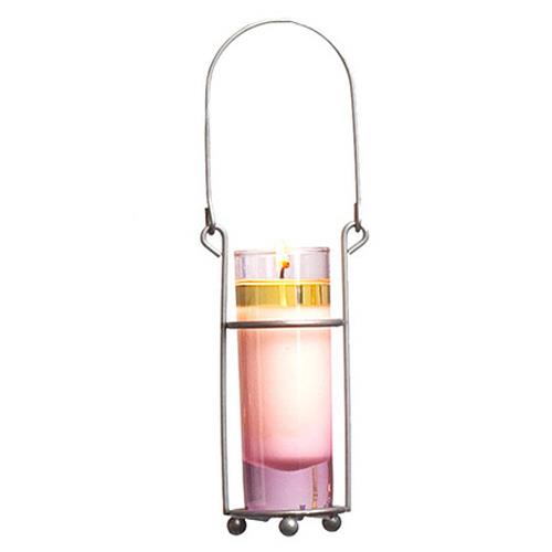 Pink candle in a glass holder with a metal handle.
