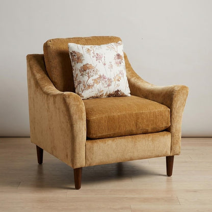 Cozy tan armchair with a floral cushion.