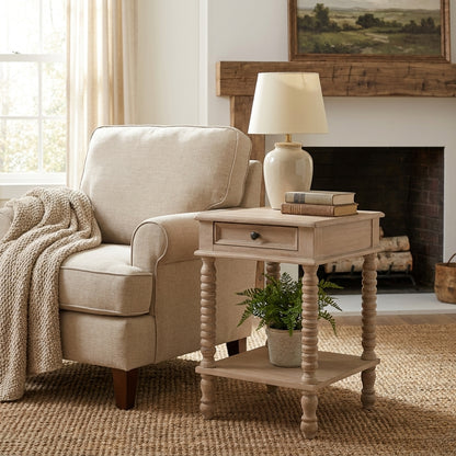 Cozy living room corner with a beige armchair, side table, and lamp.