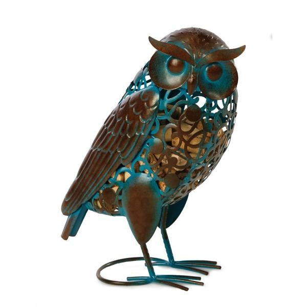 Intricate metal owl sculpture with blue accents and circular cutouts.