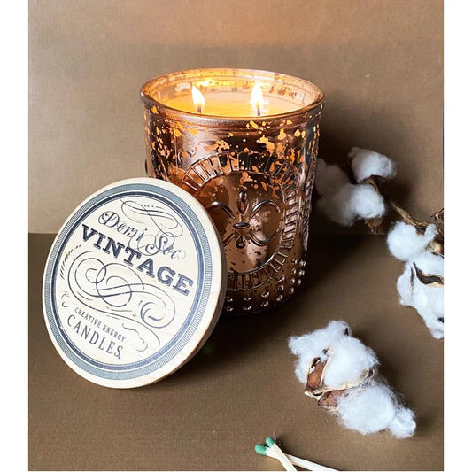 Lit vintage candle with cotton and matchsticks nearby.