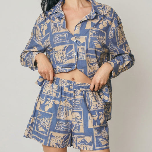 Person wearing a blue patterned shirt and matching shorts.