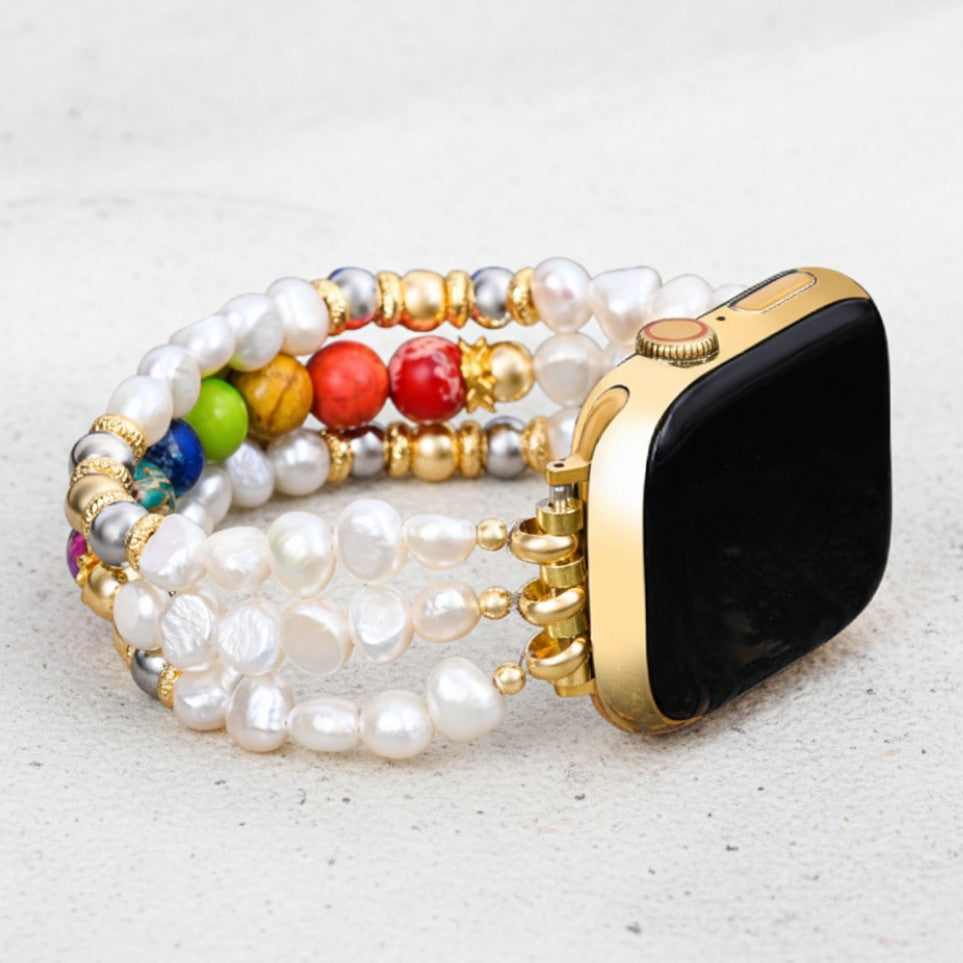 Smartwatch with colorful, beaded pearl strap on a light surface.