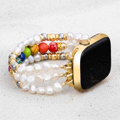 Smartwatch with colorful, beaded pearl strap on a light surface.