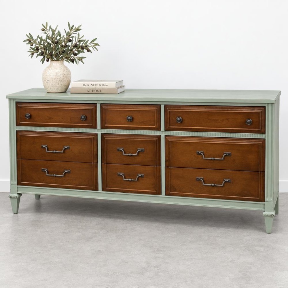 Wooden dresser with plants and books on top.