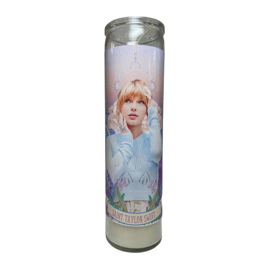 Decorative candle with artistic portrait and "Saint Taylor Swift" label.