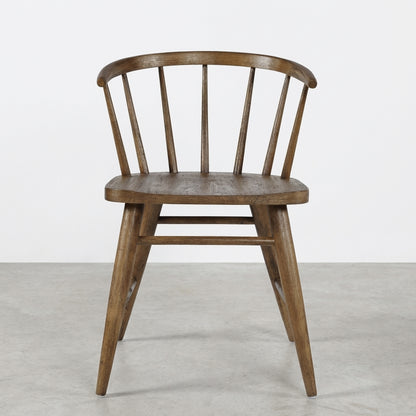 Wooden chair with a curved back and spindle design.