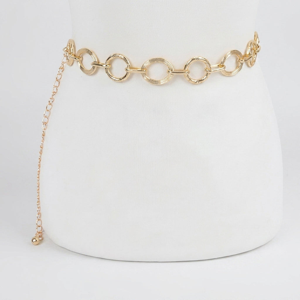 Gold chain belt with round links on a white background.