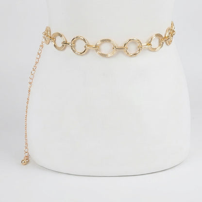 Gold chain belt with round links on a white background.