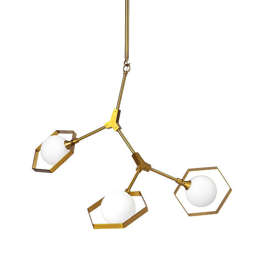 Modern brass chandelier with three globe lights in hexagonal frames.