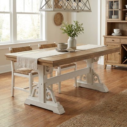 Wooden table with white ornate legs.