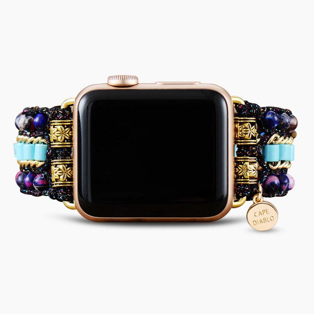 Smartwatch with a beaded, colorful strap and gold accents.