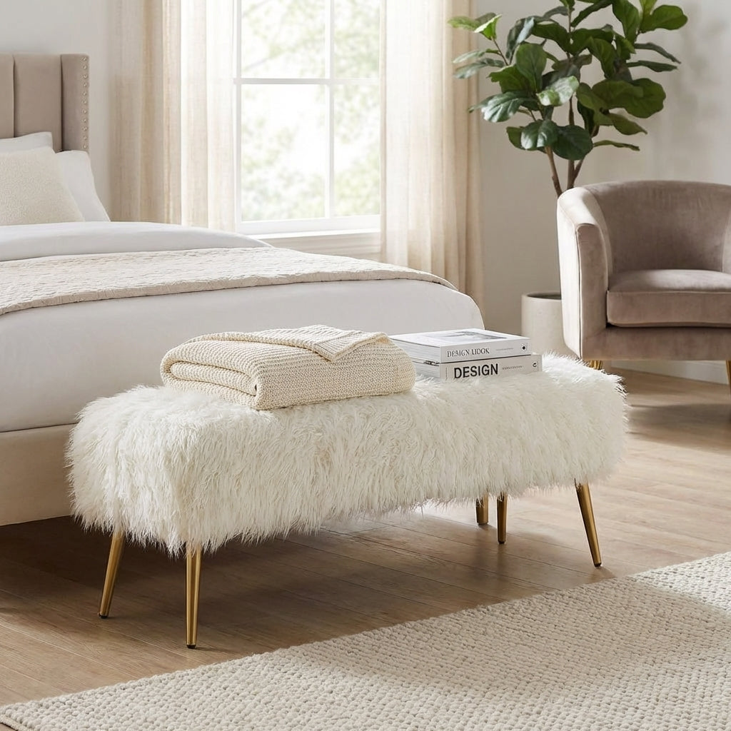 Fuzzy white bench with gold legs.