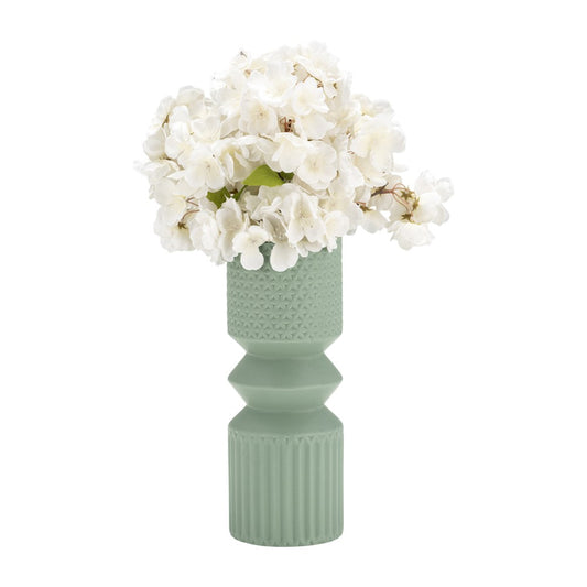 White flowers in a textured green vase.