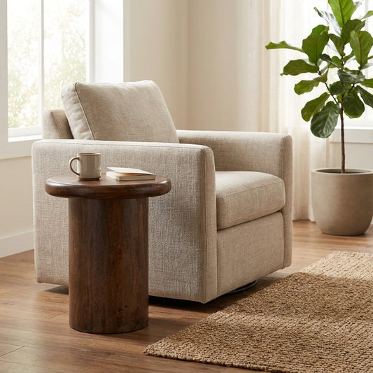 Cozy armchair with a wooden side table, book, mug, and a plant by the window.
