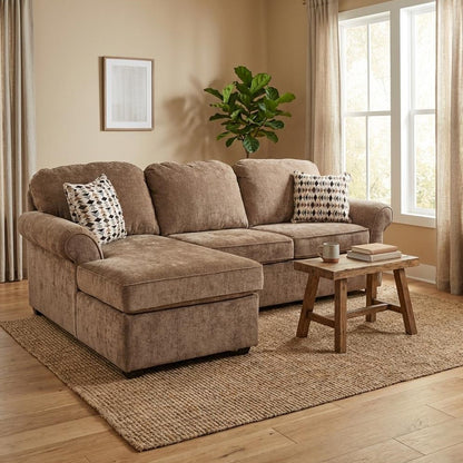 Cozy living room with plush brown sectional, wooden table, and potted plant.