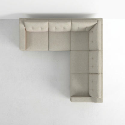 Top view of an L-shaped beige sofa on a light background.