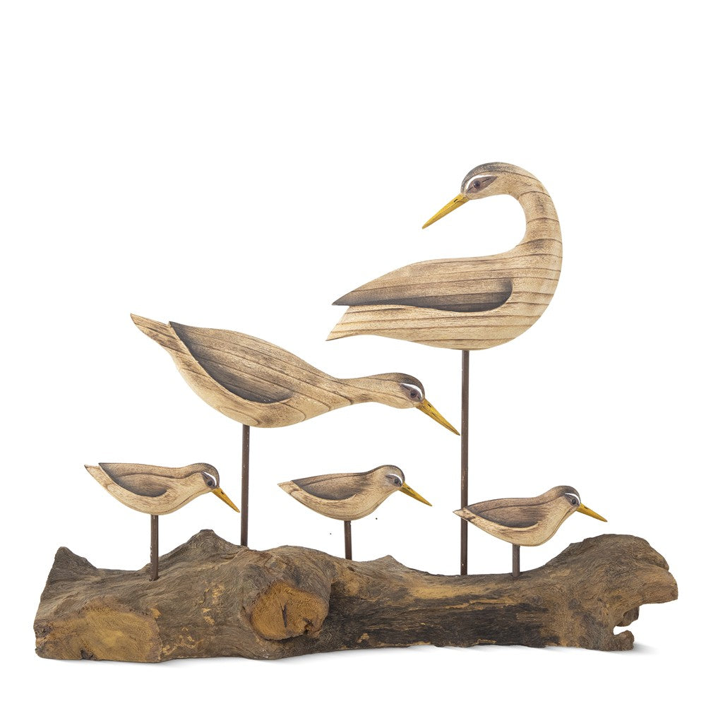Carved wooden birds on a driftwood base.