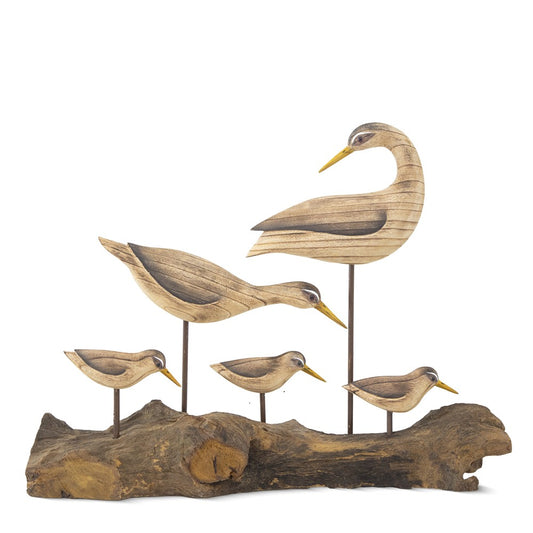 Carved wooden birds on a driftwood base.